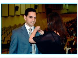 Fotografia de André Santos Navega recebendo a insígnia institucional do MPRJ