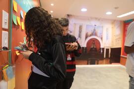 Fotografia de uma estudante da EM General Tasso Fragoso deixando uma mensagem no painel  interati...