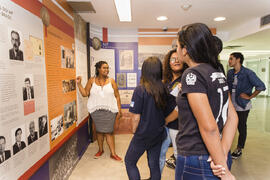 Fotografia da mediadora Nayara Cristina ouvindo os questionamentos dos alunos do Colégio Estadual...